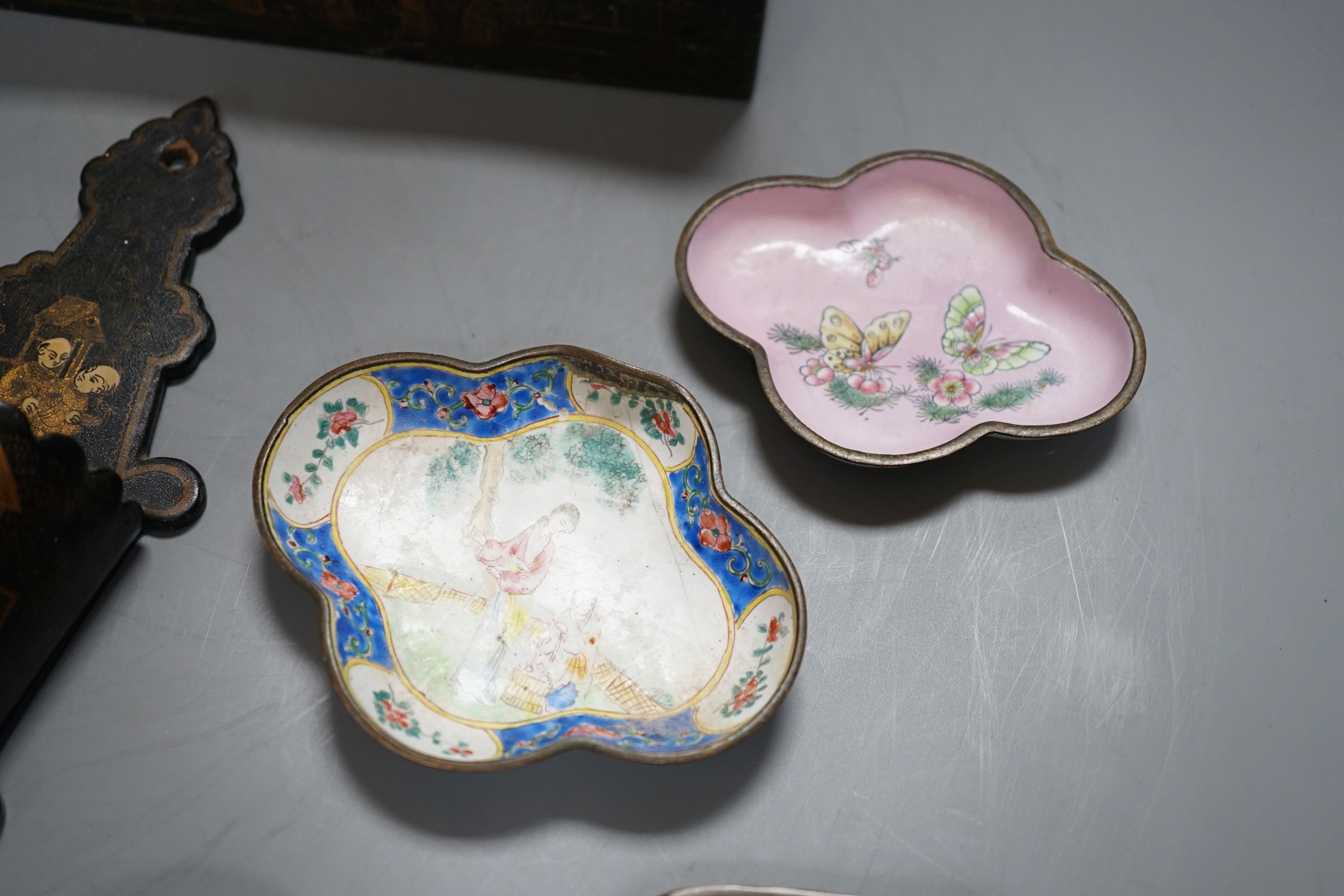 A group of five Chinese lacquered papier mache wall pockets, enamelled dishes, etc.